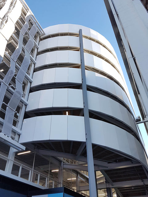 Upward view of circular vertical façade panels around The Crossing carpark ramp.