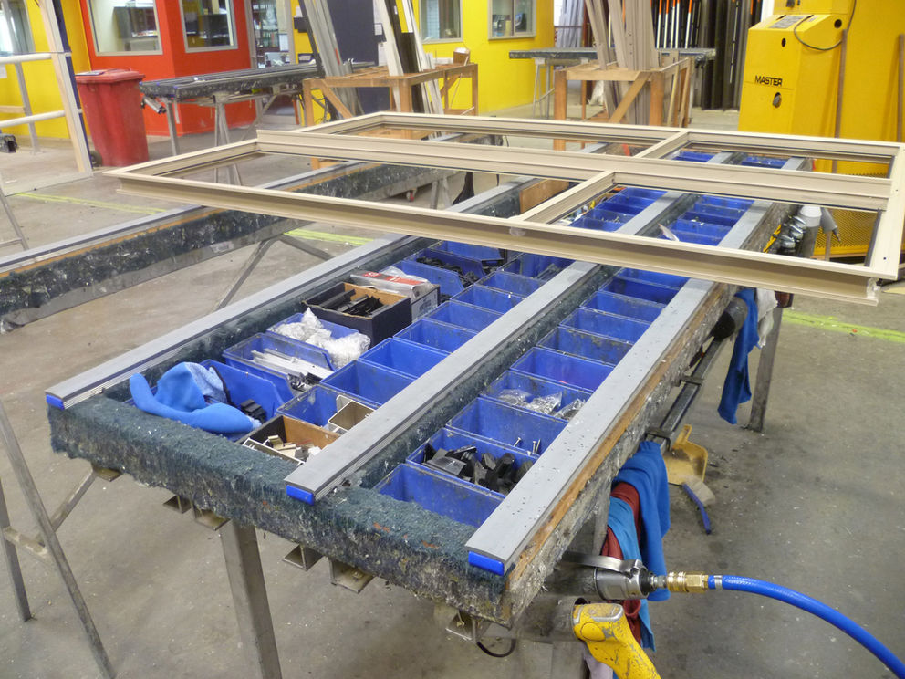 Window trestle topper inside a window factory