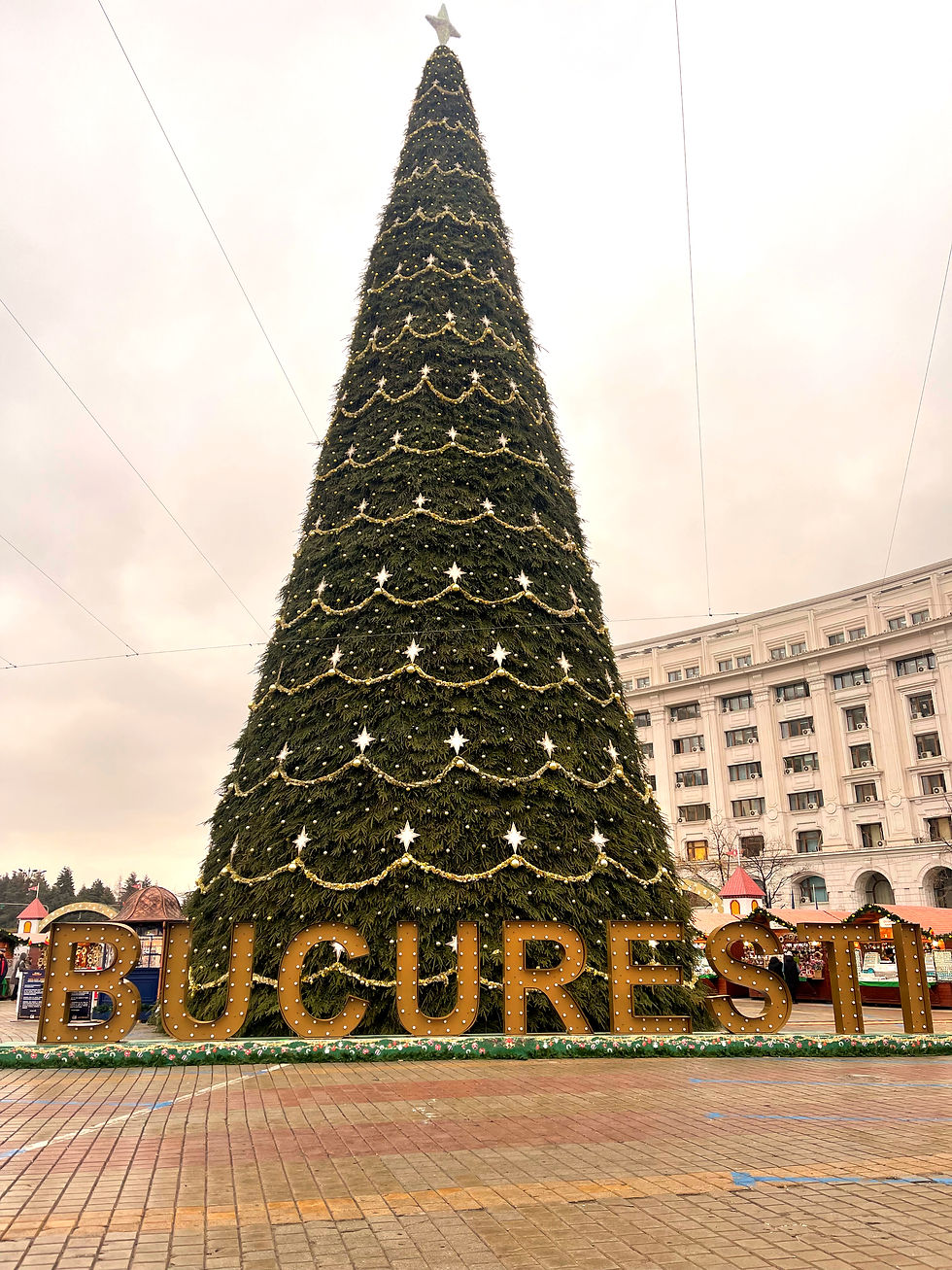 bucuresti sign in front of a tall Christmas tree in Constitution Square in Bucharest