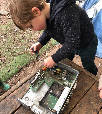 A boy at Orchidale Children's Nursery near Norwich Norfolk playing at Forest School