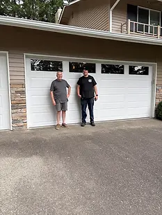 Owner of Trinitron Garage Doors installing a new garage door opener motor during a residential garage door repair service.