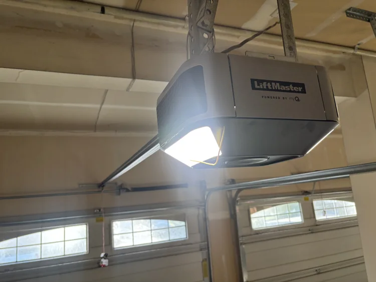 Ceiling-mounted Craftsman garage door opener above a sectional door