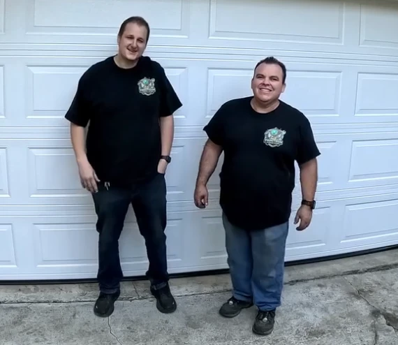 Wesley Zietz and Alfredo Armienta together in front of a garage door