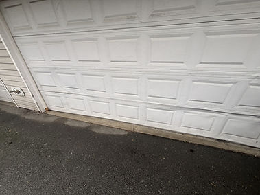 Owner of Trinitron Garage Doors installing a new garage door opener motor during a residential garage door repair service.