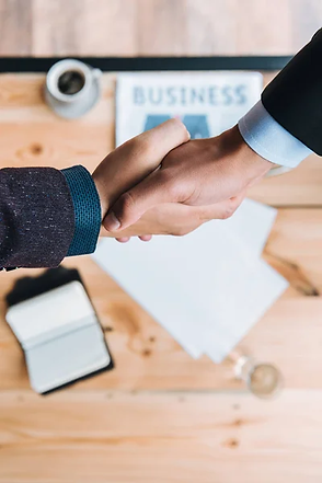 depositphotos_162643836-stock-photo-businessmen-shaking-hands-in-cafe.jpg