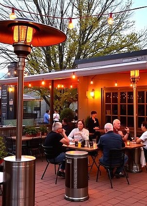beautiful patio heaters outside during the day with customers sitting down.jpg