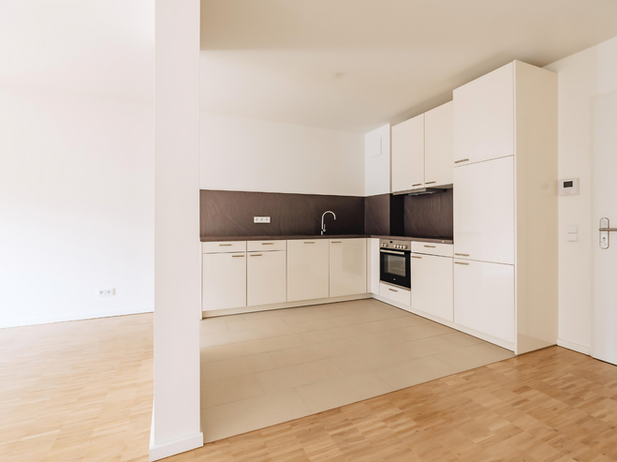 Johnsen Quartier Bremen - offene Küche mit weißen Fronten und Parkettboden
