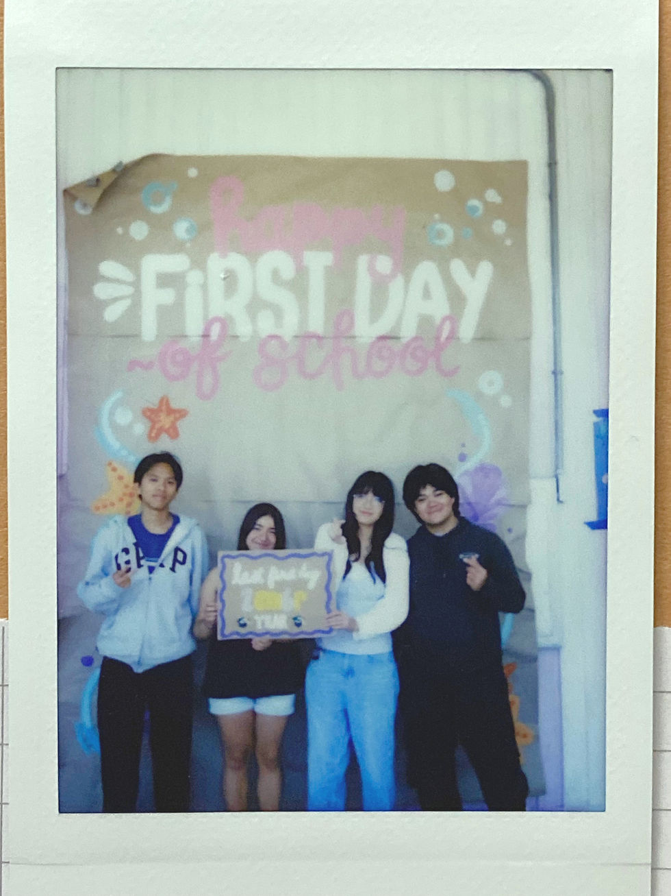 Photo by Maggie Yu | Students takes a Polaroid to capture returning back to school.
