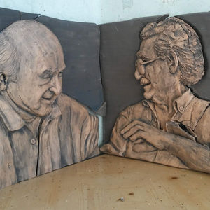 two men sculpted in terracotta as a relief 