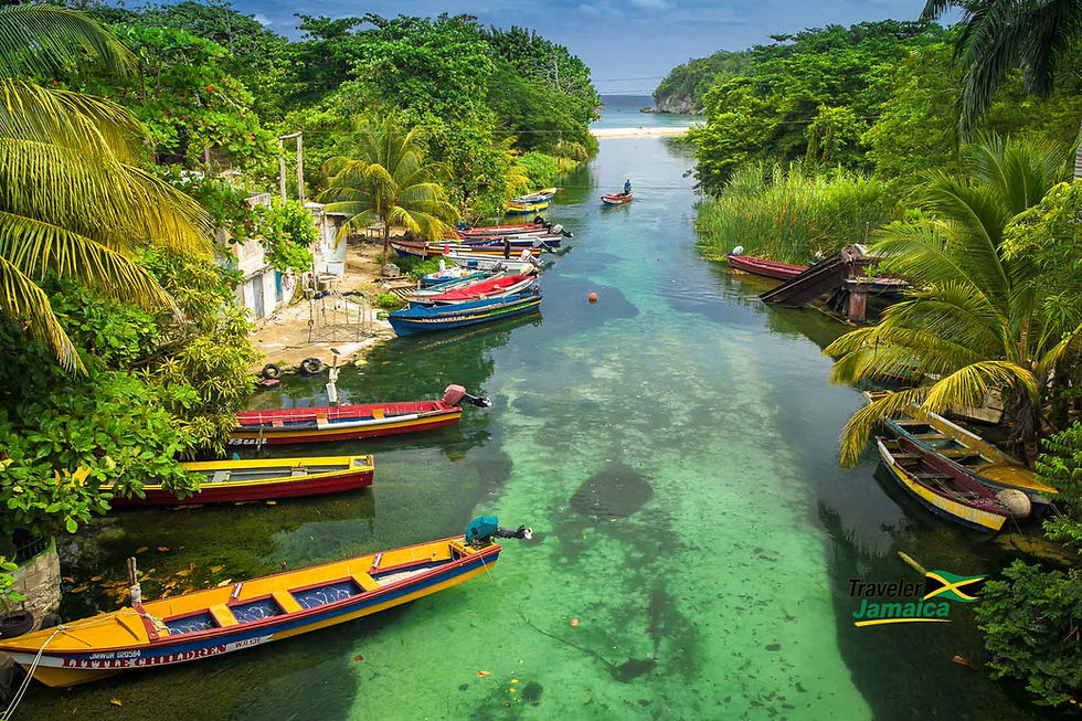Scenic Blue Lagoon in Portland, Jamaica, with vibrant fishing boats lining the clear, tranquil waters, surrounded by lush greenery under a vast blue sky.
