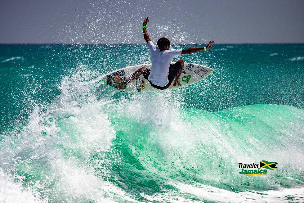 A younger Elishama "Shama" Beckford catches air on a vibrant turquoise wave, showcasing the thrill and beauty of surfing in Jamaica's pristine waters.