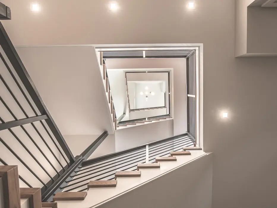 Modern multi-level staircase with wood treads, metal railings, and open vertical design in a Walworth Junction luxury home by Frazier Homes in Columbia Tusculum, Cincinnati.