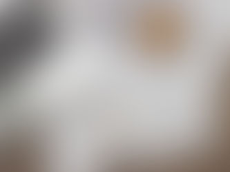 Architectural blueprints and custom home design drawings on a desk with planning tools, illustrating early-stage planning for new construction homes by Frazier Homes.