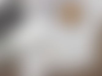 Architectural blueprints and custom home design drawings on a desk with planning tools, illustrating early-stage planning for new construction homes by Frazier Homes.