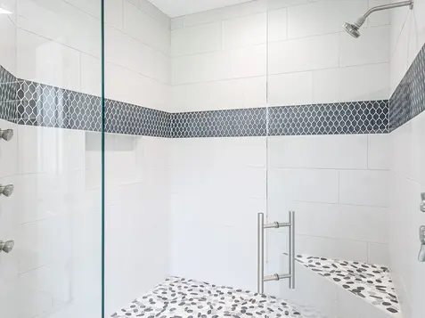 Hyde Park bathroom shower with glass enclosure, mosaic accent tile, and modern chrome fixtures in a luxury custom home by Frazier Homes Cincinnati.