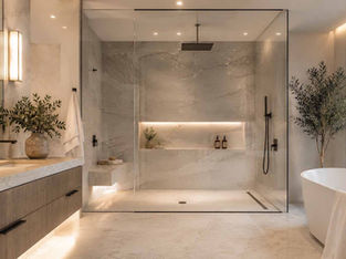 Bright luxury bathroom featuring a curbless walk-in shower, frameless glass enclosure, freestanding soaking tub, natural stone finishes, floating vanity, and spa-inspired design elements.