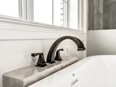 There’s something undeniably calming about a beautifully crafted freestanding tub faucet — especially one nestled into a serene, designer master bath like this Liberty Township build. This elegant fixture brings a rich, architectural presence to the space, pairing perfectly with the spa-inspired tub and custom tilework. It’s the kind of detail that transforms an ordinary bathroom into a luxurious escape, and it’s one of the many reasons our Liberty Township homes feel so timeless, elevated, and intentionally designed.