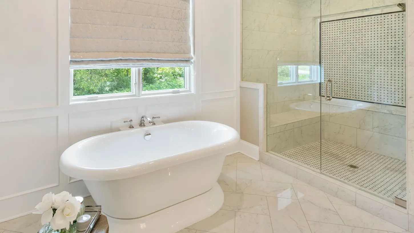 Luxury master bathroom with freestanding tub, marble tile shower, and elegant design details in a custom Frazier Homes build in Cincinnati, Ohio.