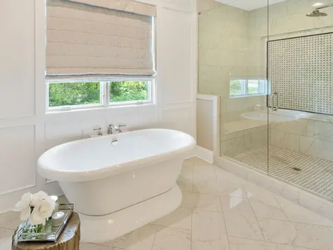 Luxury master bathroom with freestanding tub, marble tile shower, and elegant design details in a custom Frazier Homes build in Cincinnati, Ohio.