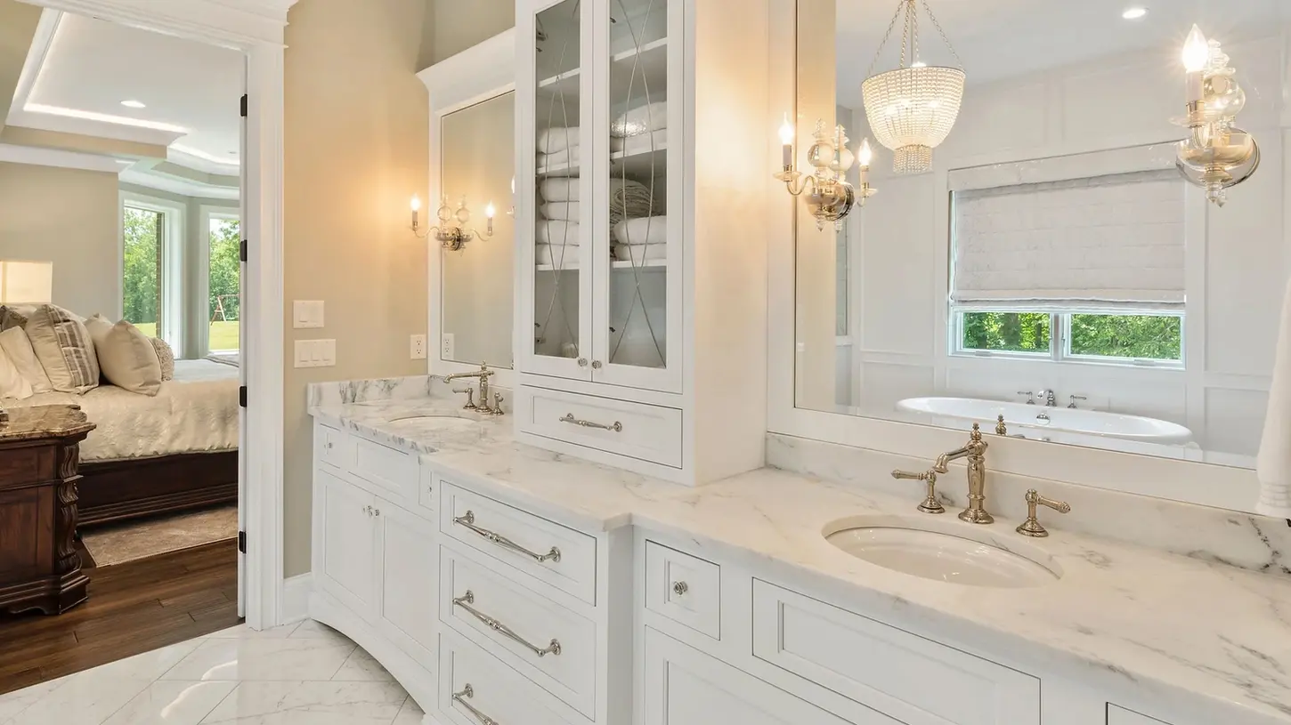 Luxury master bathroom with white double vanity, marble countertops, and polished nickel fixtures in a custom Frazier Homes build in Cincinnati, Ohio.