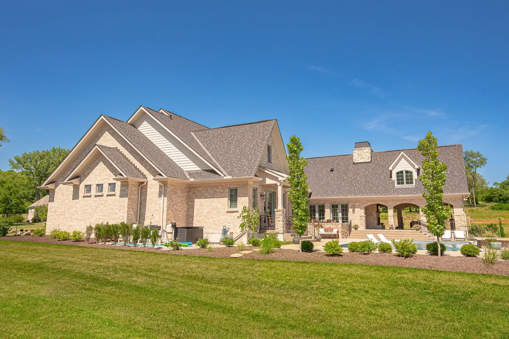 Lebanon Ohio custom home backyard by Frazier Homes featuring expansive lawn, curated landscaping, and covered outdoor living spaces designed for luxury outdoor living and everyday enjoyment.