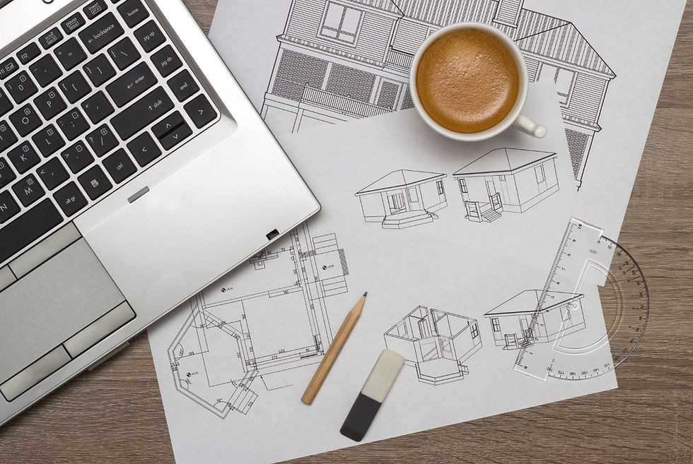 Architectural drawings and custom home design plans on a workspace, representing the personalized design process behind every Frazier Homes custom build.