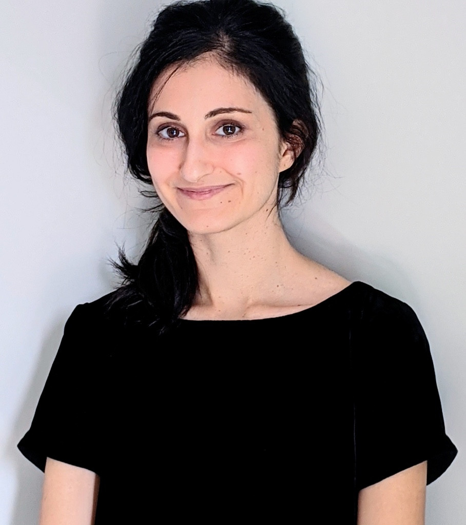 Photo of Dr. Bahri from her waist up. She has dark hair that is clipped back and is wearing a black shirt.