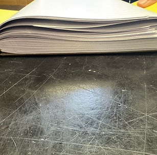 Two books are folded together to see if the power of the pull can separate them.