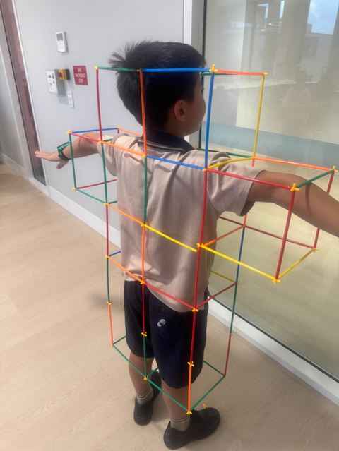Child experimenting with plastic wrap in a classroom science activity.
