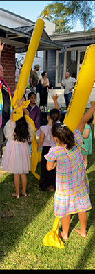 Children having fun with giant yellow Chatterbox Tubes at The Crazy Scientist STEM party.