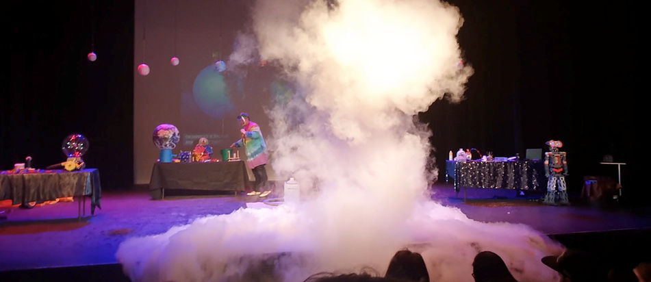 Large fog cloud from liquid nitrogen experiment on stage during live science show.
