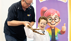 boy-holding-T-Rex arm-crazy-scientist-party-spring-farm.png