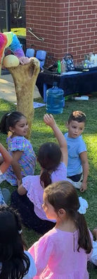 Children learning about fossils during The Crazy Scientist outdoor STEM birthday party.