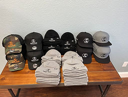 Custom embroidered hats and beanies created for Uncle Ben's Haircuts by Idaho Shirtsmith