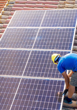 Roofer installing solar panels