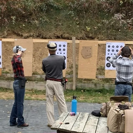 People practicing at an outdoor shooting range