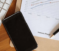 Smartphone, pen, and summary report on a desk