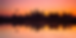 Angkor Wat temple silhouette at sunrise reflected in water