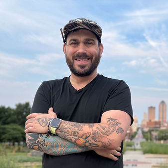 Bearded artist stands in front of #DSMUSA