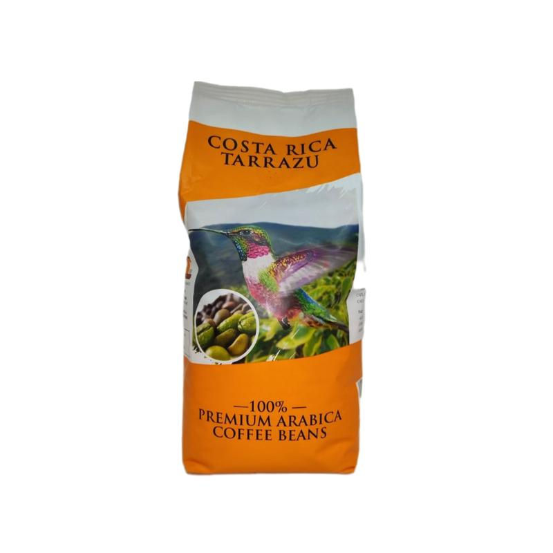 Помаранчево-біла упаковка кави Costa Rica Tarrazu 1 кг з колібрі, пейзажем та зеленими кавовими зернами.