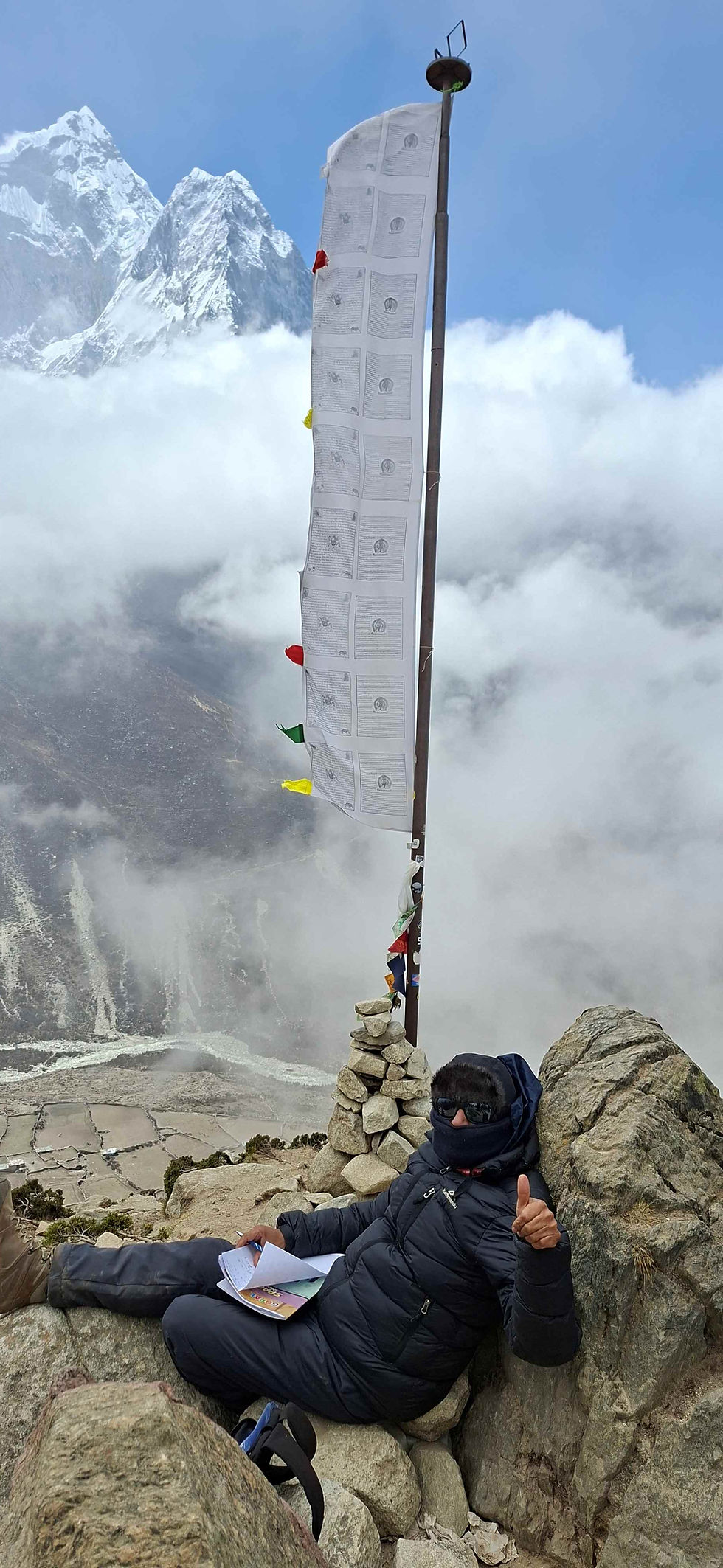 Sheshadri the writer and poet from the group taking a moment to write atop Nagarjuna Hill (3000 meters above sea level) during an acclimatization trek.