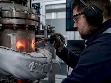 Engineer measuring heat on pressure vessel jacket