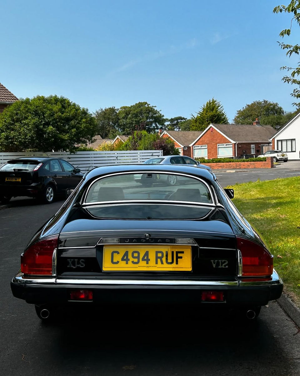 Rear view of a freshly valeted Jaguar XJS with a high-gloss finish, emphasizing expert cleaning and detailing work