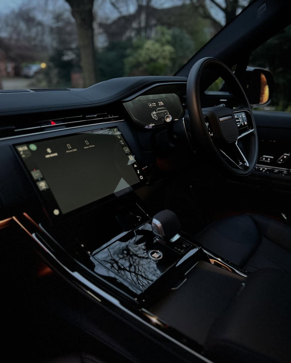Spotless Range Rover interior featuring a gleaming infotainment system and pristine dashboard after professional detailing