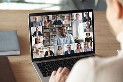 Back view of female employee speak talk on video call with diverse multiracial colleagues