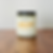Adelphi University New York branded candle on a wooden surface.