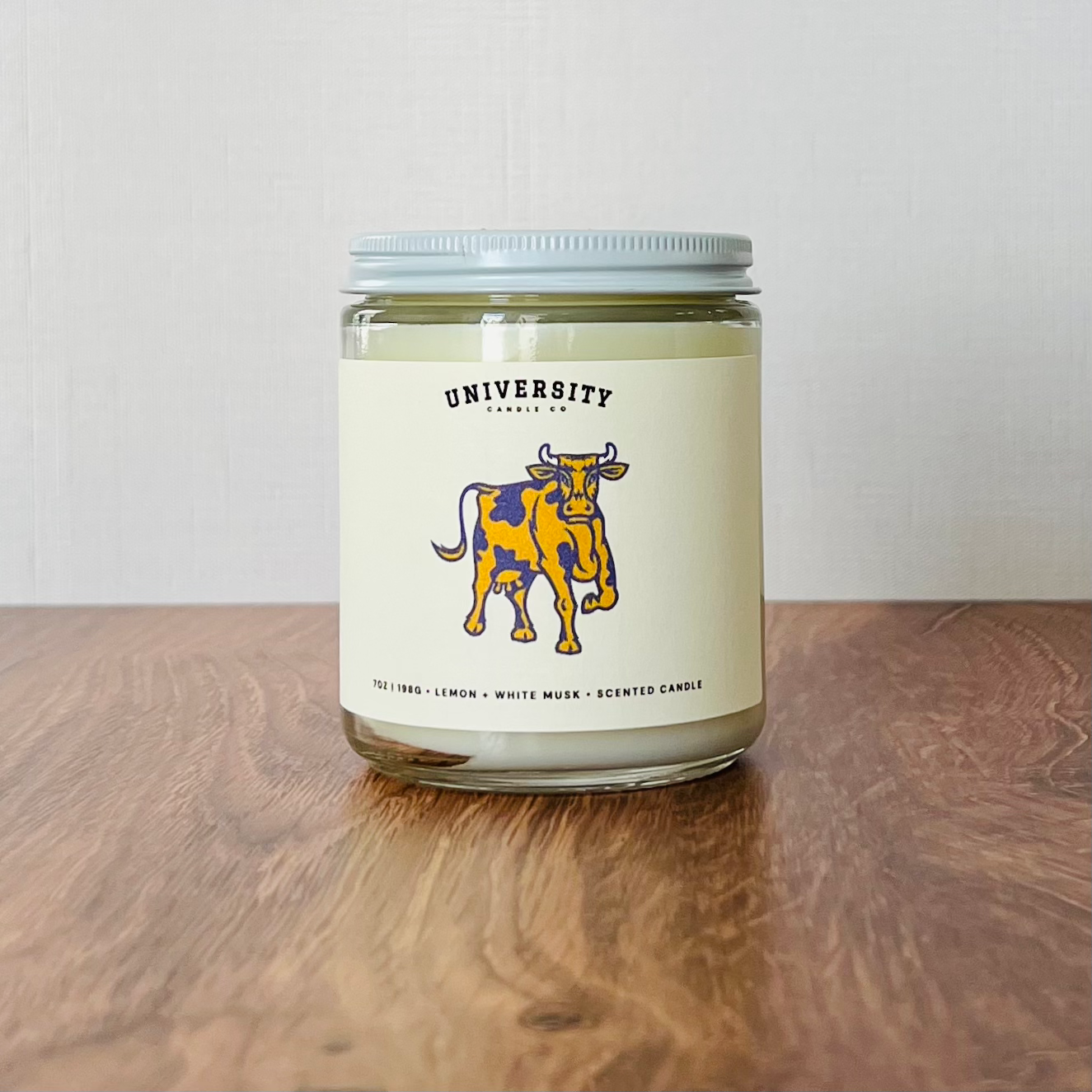 Glass jar candle, UNIVERSITY CANDLE CO. logo, Lemon White Musk Sandalwood.