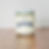 Hopkins University Candle Co. Mint + Green Tea 7oz candle on wood.