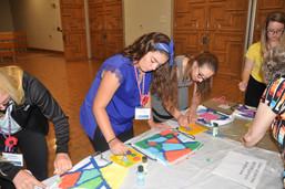 Students painting bags for school supplies.