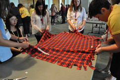 Delegates working on a lap blanket.